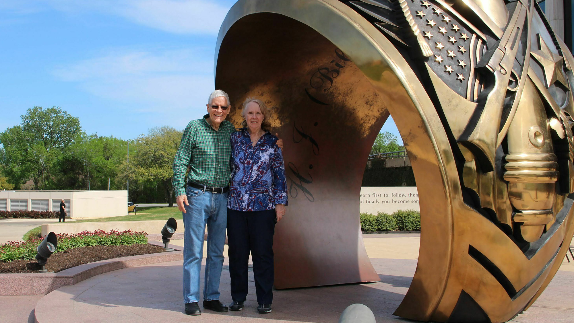 Two people at statue.