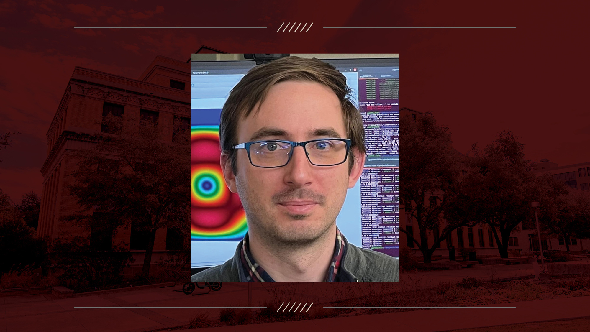 A headshot of a man on a maroon background.