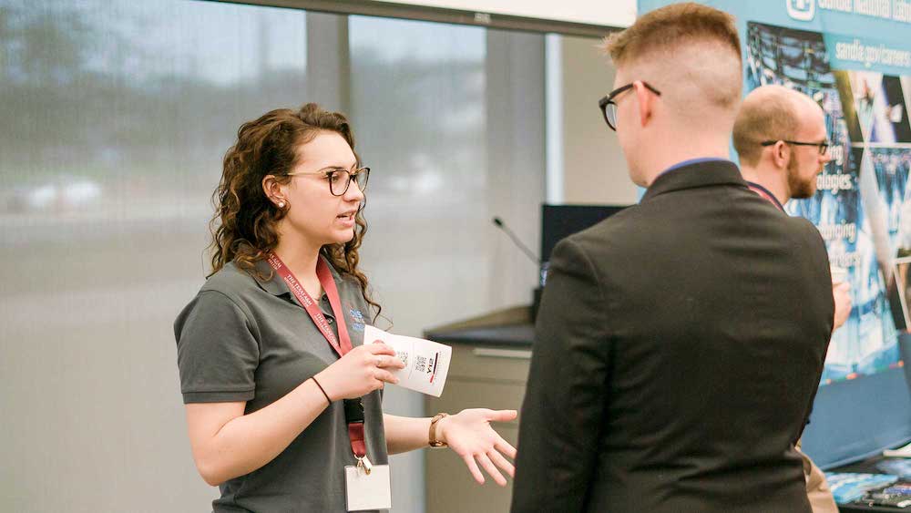 A female students talking to another student at NSSE event.