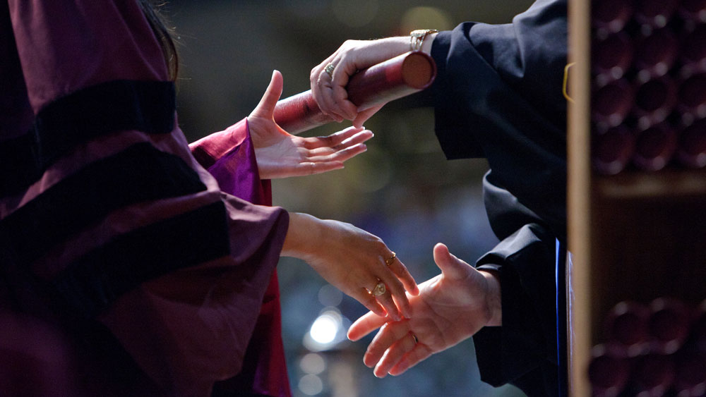 A student receiving their degree at graduation