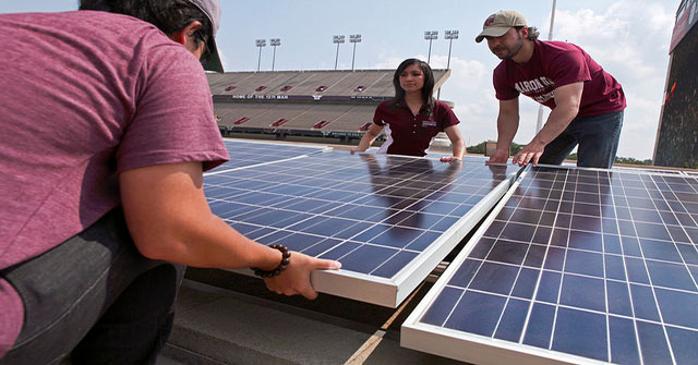 Student laying down solar panel