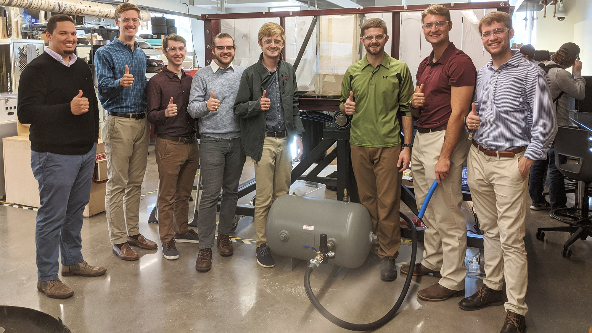 Team standing in front of project